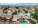 Aerial view of home with pool, covered patio, grassy backyard, and RV parking in a residential neighborhood at 609 W Mcnair St, Chandler, AZ 85225