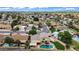 Wide aerial view of home with a pool, lush landscaping, patio, and hot tub at 609 W Mcnair St, Chandler, AZ 85225