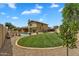 Spacious backyard featuring a well-maintained lawn, refreshing pool, and mature trees for shade at 609 W Mcnair St, Chandler, AZ 85225