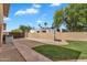 Spacious backyard with gravel, grass, tall privacy wall and a basketball hoop at 609 W Mcnair St, Chandler, AZ 85225