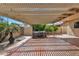 Relaxing covered patio with pergola, hot tub, and desert landscaping at 609 W Mcnair St, Chandler, AZ 85225