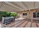 Inviting covered patio with hot tub, ceiling fan, and desert landscaping at 609 W Mcnair St, Chandler, AZ 85225