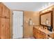 Cozy bathroom featuring a wood vanity, decorative mirror, and natural finishes at 609 W Mcnair St, Chandler, AZ 85225