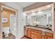 Bright bathroom with a double sink vanity, granite countertops and separate toilet room at 609 W Mcnair St, Chandler, AZ 85225