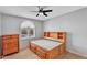 Bright bedroom featuring an arched window, neutral walls, and a classic wooden dresser at 609 W Mcnair St, Chandler, AZ 85225