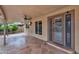 Spacious covered patio with flagstone flooring, ceiling fan, mounted TV, and access to the backyard at 609 W Mcnair St, Chandler, AZ 85225