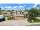Two-story home with a stone and tan exterior, large driveway, RV gate, and well-manicured lawn at 609 W Mcnair St, Chandler, AZ 85225