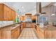 Spacious kitchen with stainless steel appliances, center island, and bright lighting at 609 W Mcnair St, Chandler, AZ 85225