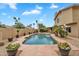 Private backyard pool surrounded by lush landscaping and a covered outdoor seating area at 609 W Mcnair St, Chandler, AZ 85225