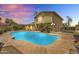 Stunning backyard pool with flagstone surround, lush landscaping, and covered patio is perfect for relaxing and entertaining at 609 W Mcnair St, Chandler, AZ 85225