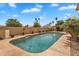 Backyard in-ground pool with flagstone surround and lush landscaping creating a private oasis at 609 W Mcnair St, Chandler, AZ 85225