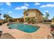 Backyard features a sparkling blue pool, covered patio, and desert landscaping for outdoor living and enjoyment at 609 W Mcnair St, Chandler, AZ 85225