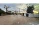 Spacious backyard showcasing desert landscaping, storage sheds, and distant structures at 8125 E 5Th Ave, Mesa, AZ 85208