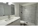 Updated bathroom featuring a new vanity, mirror, and a walk-in shower at 8125 E 5Th Ave, Mesa, AZ 85208