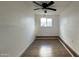 Neutral bedroom featuring wood-look floors, a ceiling fan, and a sunny window at 8125 E 5Th Ave, Mesa, AZ 85208