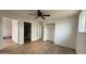 Bright bedroom featuring wood-look floors, a ceiling fan, and multiple doorways for easy access at 8125 E 5Th Ave, Mesa, AZ 85208