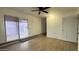 Bedroom with wood-look floors, ceiling fan, and sliding glass door for access to the exterior at 8125 E 5Th Ave, Mesa, AZ 85208