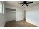 Bright bedroom showcasing wood-look floors, a ceiling fan, and closet space at 8125 E 5Th Ave, Mesa, AZ 85208