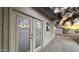 Cream-colored home's exterior showcasing double doors and a side window against the desert backdrop at 8125 E 5Th Ave, Mesa, AZ 85208