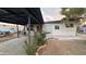 Exterior of home featuring a covered patio, neutral paint, desert landscaping, and a chain-link fence at 8125 E 5Th Ave, Mesa, AZ 85208