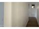 A hallway is illuminated by a door with a window allowing natural light to enter the area at 8125 E 5Th Ave, Mesa, AZ 85208
