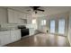 Modern kitchen featuring white cabinets, stainless steel appliances, and wood-look floors at 8125 E 5Th Ave, Mesa, AZ 85208