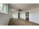An open-concept living room with wood-look floors, white walls, and natural light from many windows at 8125 E 5Th Ave, Mesa, AZ 85208