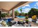 Relaxing backyard patio features a sparkling pool with tropical landscaping, perfect for outdoor entertaining at 9059 E Butherus Dr, Scottsdale, AZ 85260