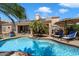 Relaxing backyard with a refreshing pool, patio seating, and a well-maintained garden for outdoor enjoyment at 9059 E Butherus Dr, Scottsdale, AZ 85260