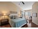 Serene primary bedroom with a ceiling fan, plush bedding, and ample natural light from windows with stylish shutters at 9059 E Butherus Dr, Scottsdale, AZ 85260