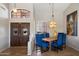 Elegant dining room with stylish lighting, wood table, and views of the front door at 9059 E Butherus Dr, Scottsdale, AZ 85260