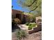 Lovely home exterior featuring a landscaped yard, walkway, and desert plants at 9059 E Butherus Dr, Scottsdale, AZ 85260