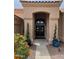 Inviting front entry with arched doorway, double doors, and manicured landscaping at 9059 E Butherus Dr, Scottsdale, AZ 85260