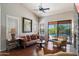 Inviting living room with plantation shutters, comfortable seating, and view of a refreshing pool area through sliding doors at 9059 E Butherus Dr, Scottsdale, AZ 85260
