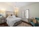 Comfortable main bedroom with plush rug, accent chair, and plantation shutters at 9059 E Butherus Dr, Scottsdale, AZ 85260
