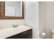 Half bath showing vanity with framed mirror, toilet and vanity with faux marble top, with neutral wall color at 9435 S 33Rd Dr, Laveen, AZ 85339