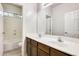 Bathroom with double sink vanity, and shower with light from window above at 9435 S 33Rd Dr, Laveen, AZ 85339