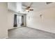 Spacious bedroom featuring neutral walls, carpet, three small windows, and ceiling fan at 9435 S 33Rd Dr, Laveen, AZ 85339