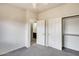 Bedroom with gray carpets, closet, and a view into the attached bathroom at 9435 S 33Rd Dr, Laveen, AZ 85339