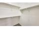 Walk-in closet providing ample storage space with shelves and clothing rods installed at 9435 S 33Rd Dr, Laveen, AZ 85339