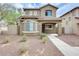 Inviting two-story home featuring a desert-landscaped front yard and covered entryway at 9435 S 33Rd Dr, Laveen, AZ 85339