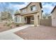 Inviting two-story home with an arched entryway and desert-friendly landscaping at 9435 S 33Rd Dr, Laveen, AZ 85339