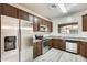Well-lit kitchen featuring wood cabinets, stainless steel appliances, and gray countertops at 9435 S 33Rd Dr, Laveen, AZ 85339
