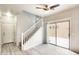 Bright living room featuring a ceiling fan, wood-look floors, and a sliding glass door to the outside patio at 9435 S 33Rd Dr, Laveen, AZ 85339