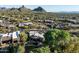 Aerial view of a luxury home nestled in the desert landscape with mountain views at 9726 E Hidden Green Dr, Scottsdale, AZ 85262