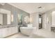 Bright bathroom featuring a modern tub, dual sinks, and a separate shower area at 9726 E Hidden Green Dr, Scottsdale, AZ 85262