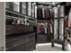 Custom designed walk-in closet with built-in storage and ample hanging space at 9726 E Hidden Green Dr, Scottsdale, AZ 85262