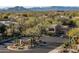 Scenic view of community entrance featuring desert landscaping, gatehouse, and mountain views at 9726 E Hidden Green Dr, Scottsdale, AZ 85262