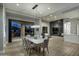 Open-concept dining room showcasing modern chandelier, sleek table, and seamless access to outdoor living space at 9726 E Hidden Green Dr, Scottsdale, AZ 85262