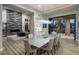 Bright dining room with a large table, modern chandelier, and sliding glass doors to the backyard patio at 9726 E Hidden Green Dr, Scottsdale, AZ 85262